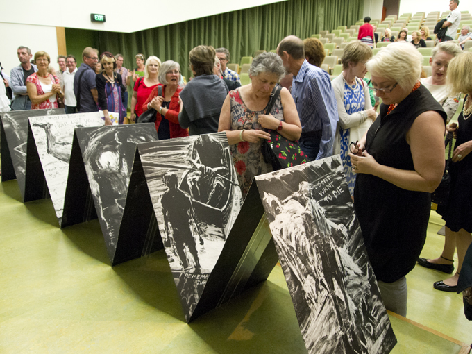 Attendees viewing the 'Hearsay' book
