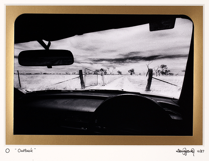 O Outback. An open gate, and two tyre tracks pointing toward infinity best expresses the great expanse of wide-open space that is the outback. Near Scopes Range Bore Western, New South Wales.
