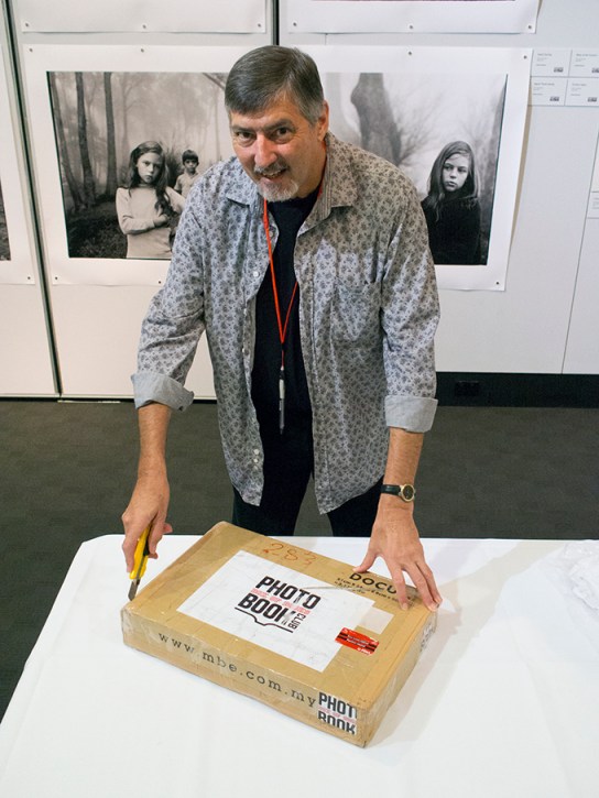 Convener of the event Doug Spowart opens the Box of Books