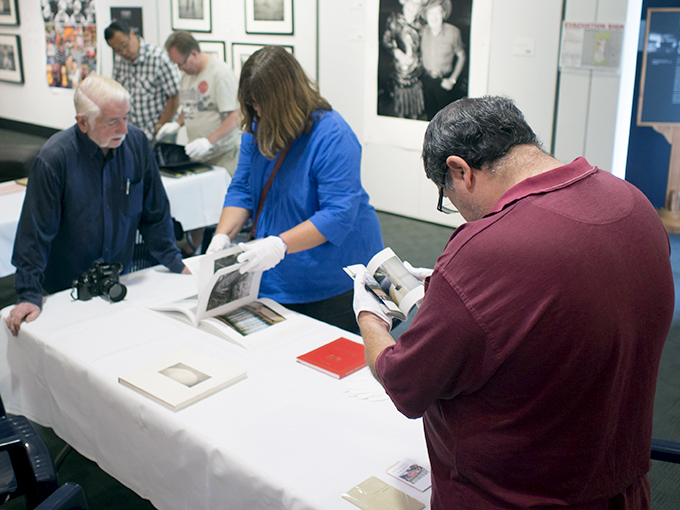 Gerry Saide looking closely at a book
