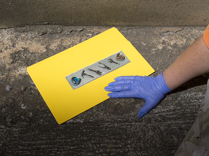 A Capricornia Printmaker's hand and cyanotype being exposed