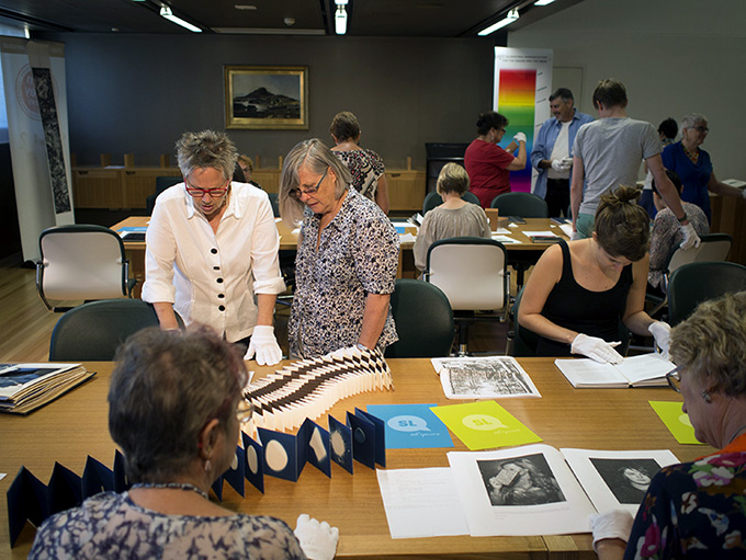 SLQ White Gloves event - Attendees viewing books