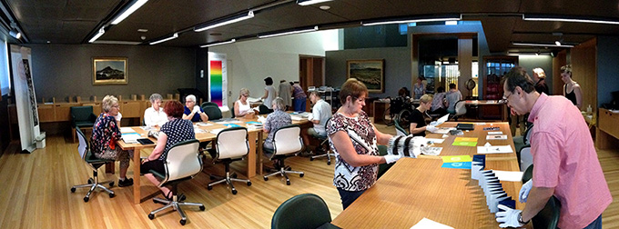 SLQ White Gloves event - Attendees viewing books