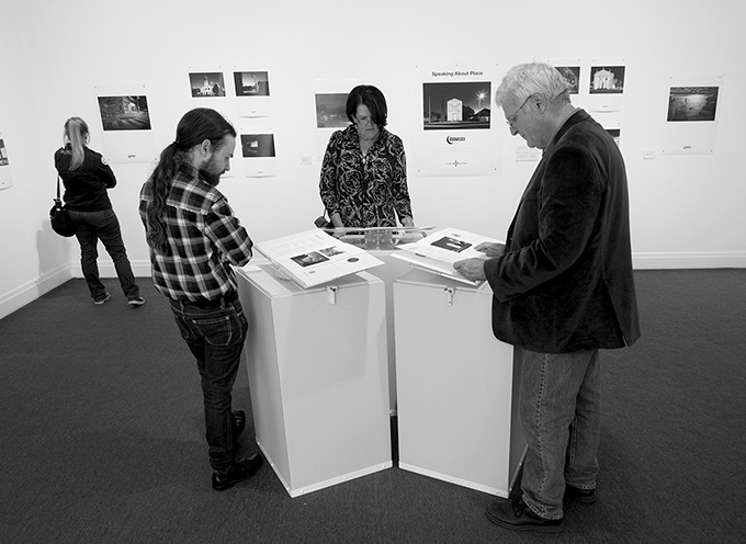 Exhibition viewers reading Facebook responses