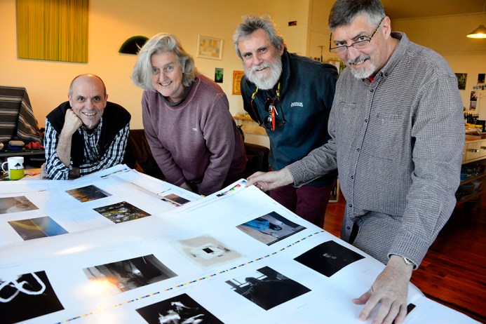 Ian Skinner, Vicky, Roger and Doug looking at proofs