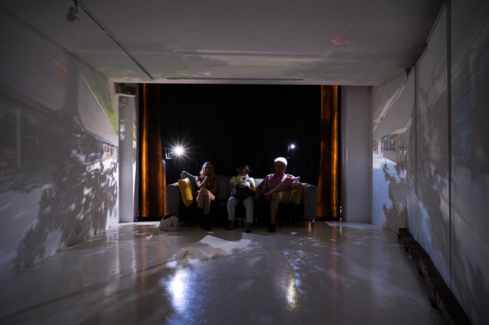Camera obscura viewers sitting on the couch - note two holes... PHOTO: Louis Lim