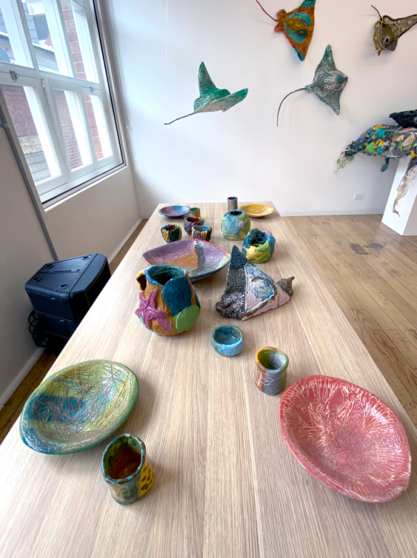 Georgia Szmerling ceramics (front) &amp; Erub ArtsTorres Strait and Ghost Net Collective (back wall)